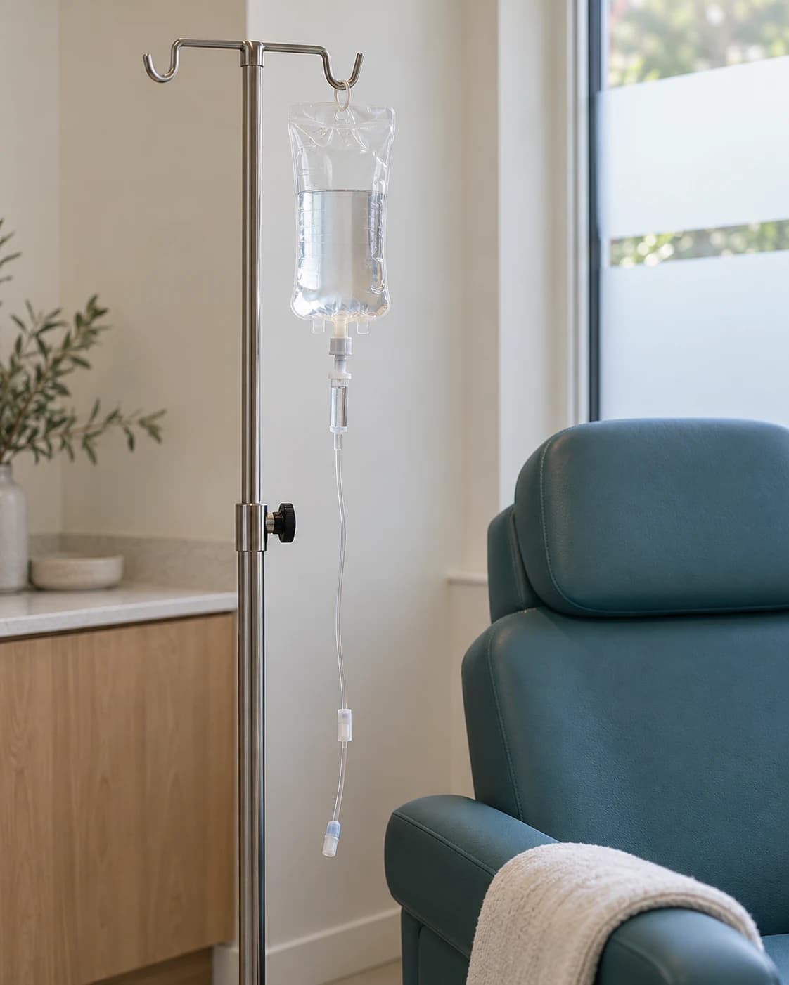 Illustrative infusion equipment beside a clinical chair